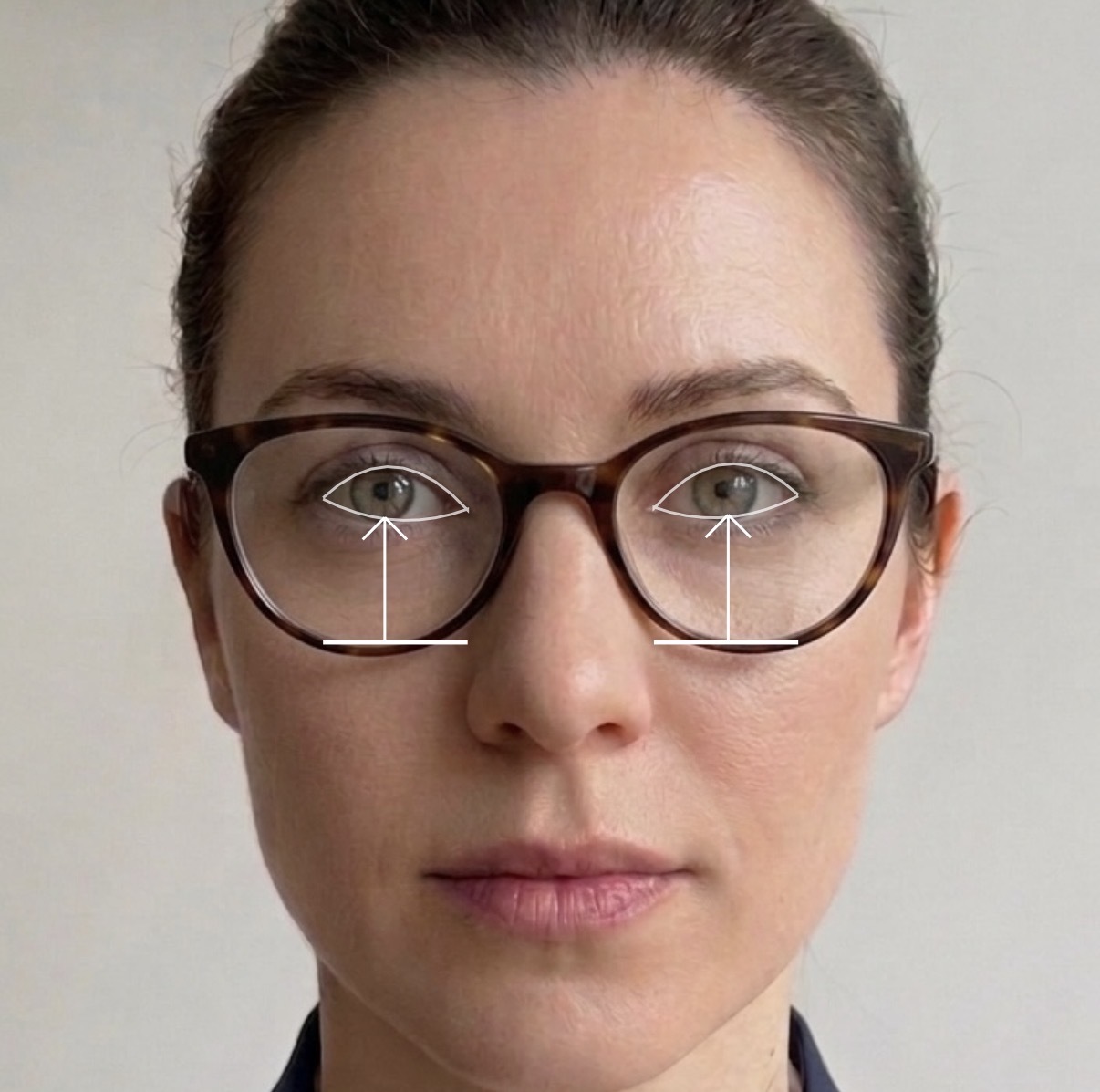 Pupillary distance and fitting height measurement overlays on a woman wearing glasses in the Zernike Vision iPhone app